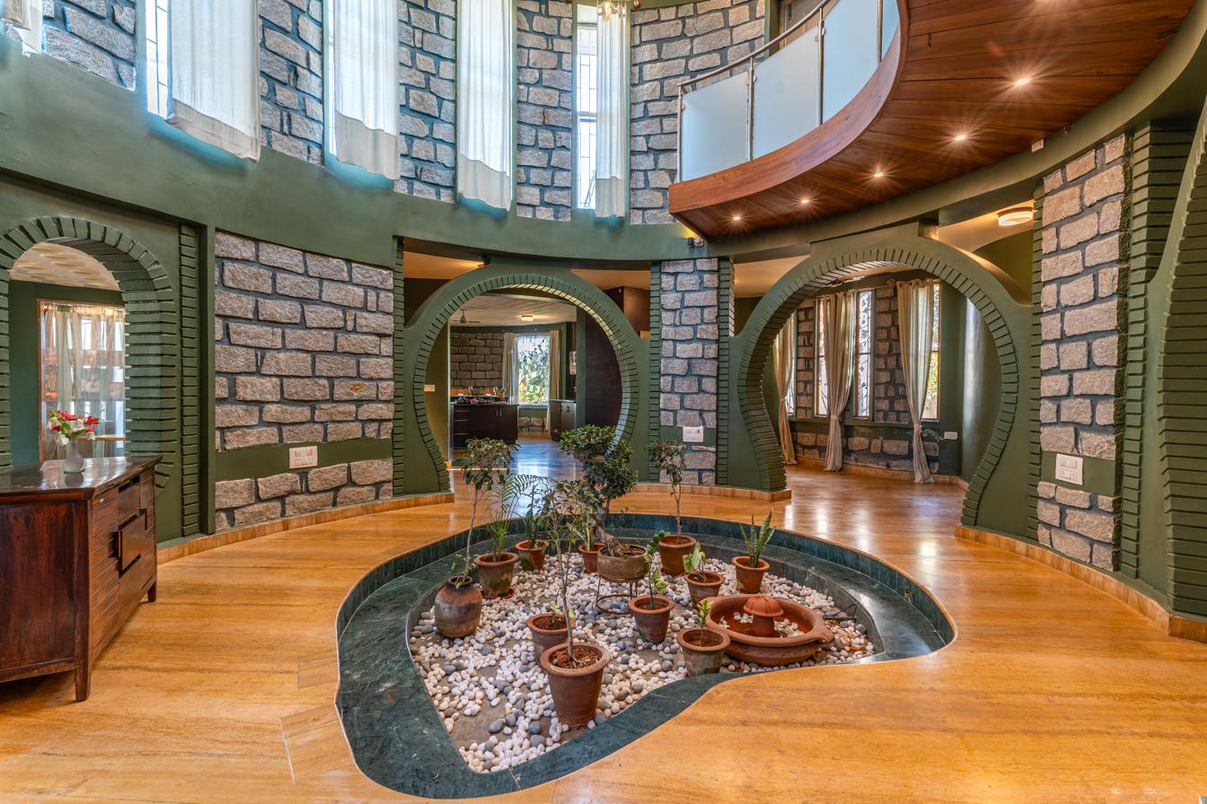 Wide view of the atrium showing three curved archways and the sunken courtyard garden