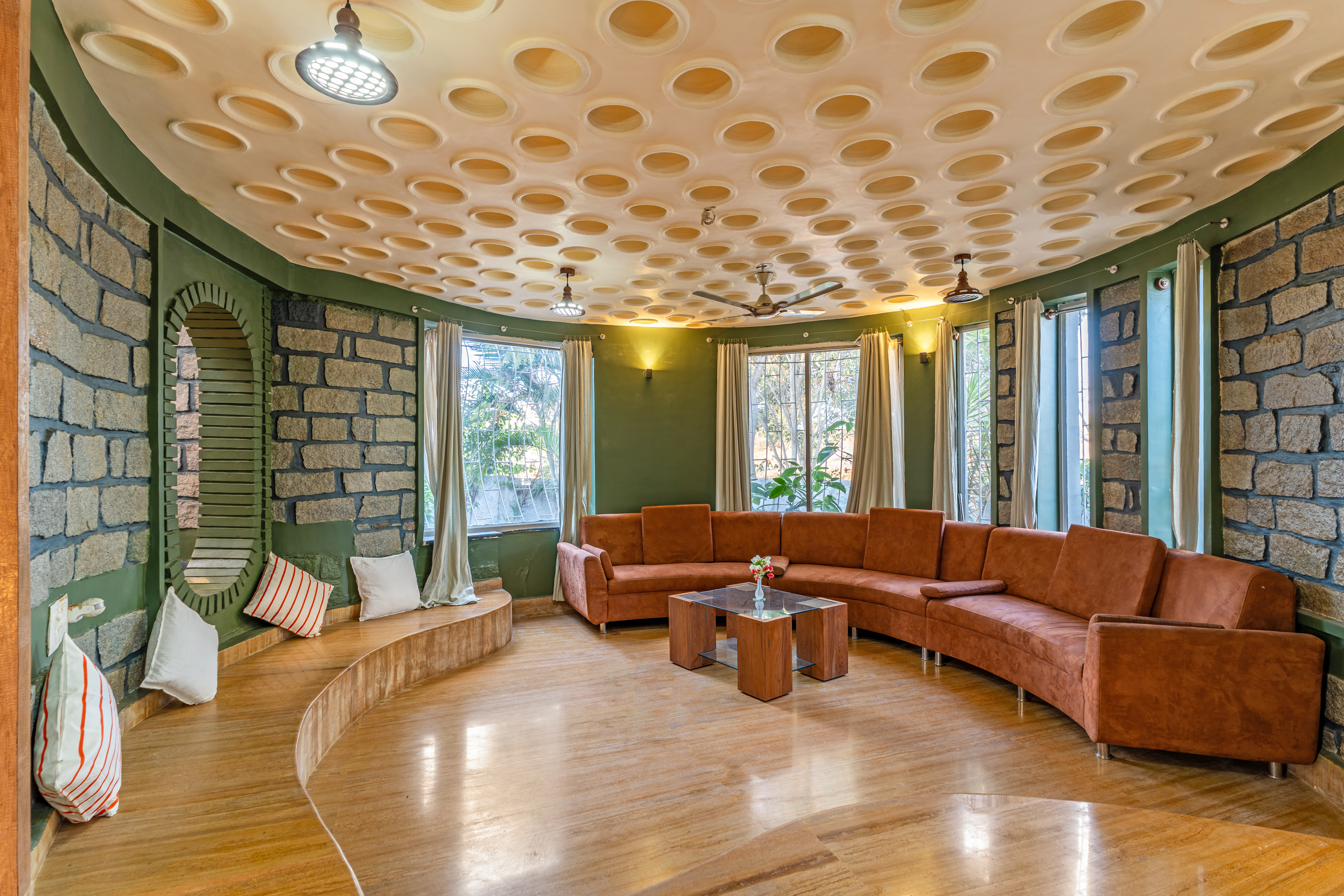 Curved living room with honeycomb-textured ceiling and curved sofa